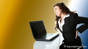 a person Severna Park bending over a computer holding her back due to pain