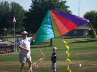 Severna Park back pain free grandpa and grandson playing with a kite